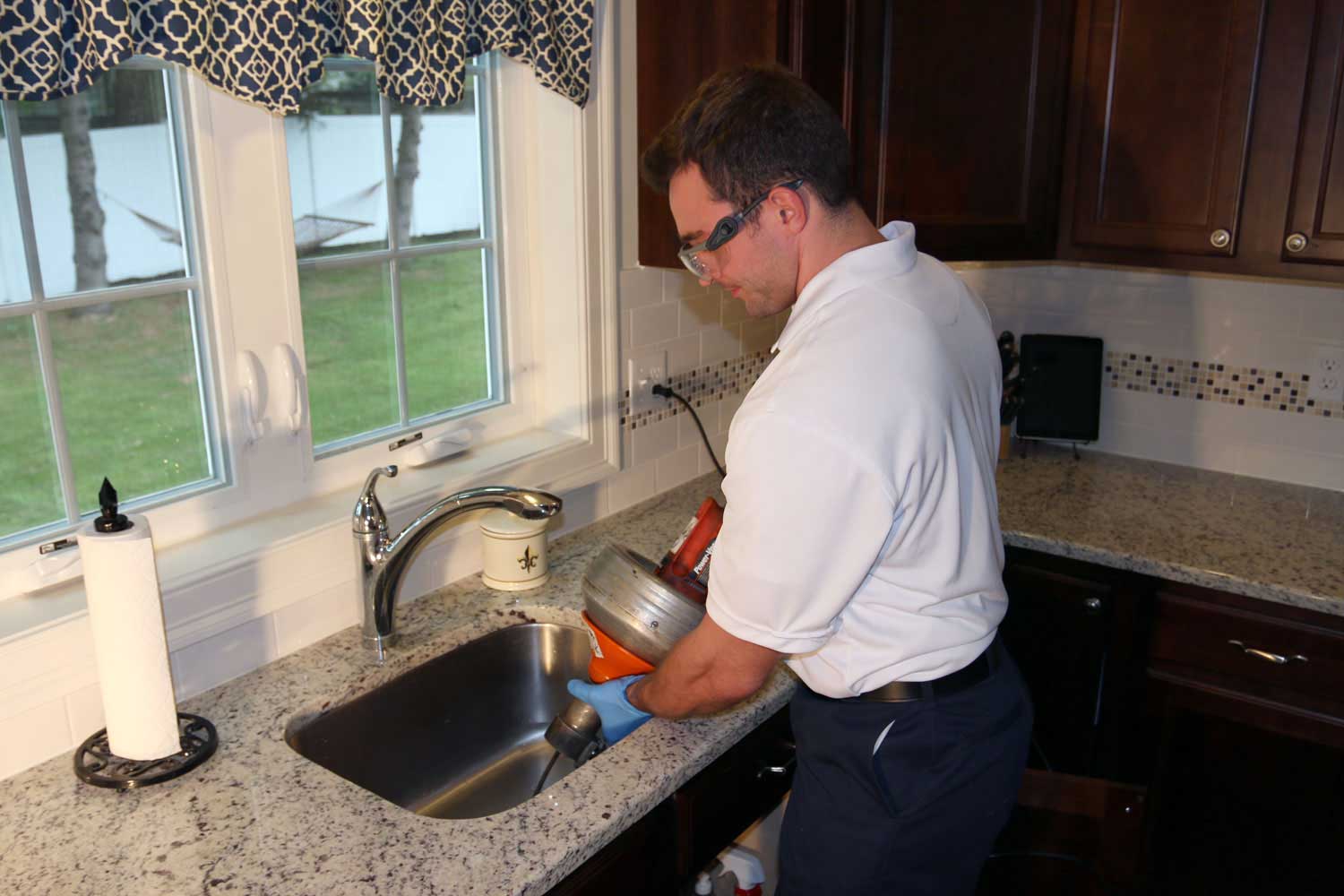 technician fixing the kitchen sink