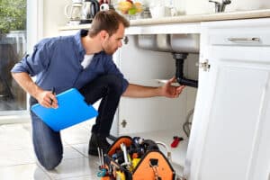 plumber inspecting plumbing fixtures
