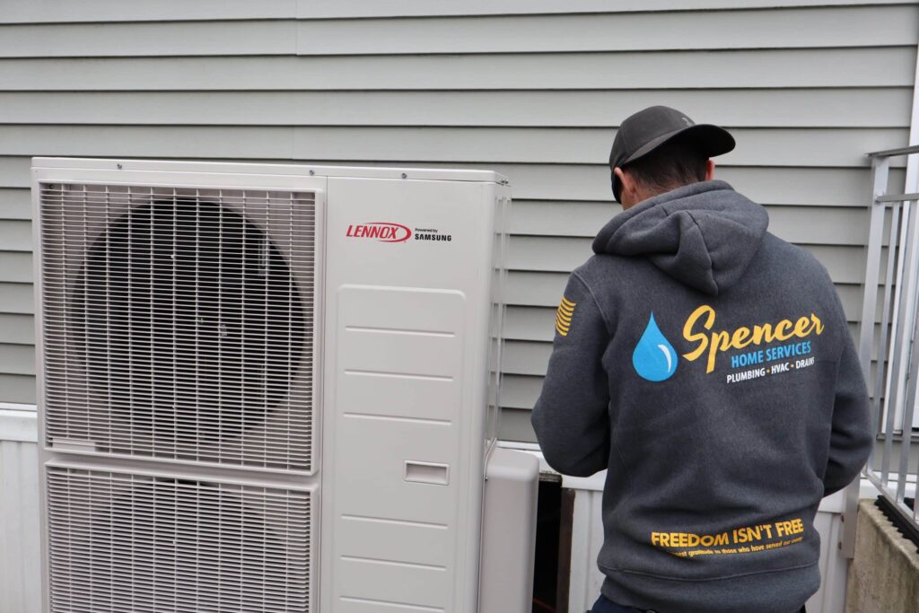 Spencer Home Services technician servicing heating equipment