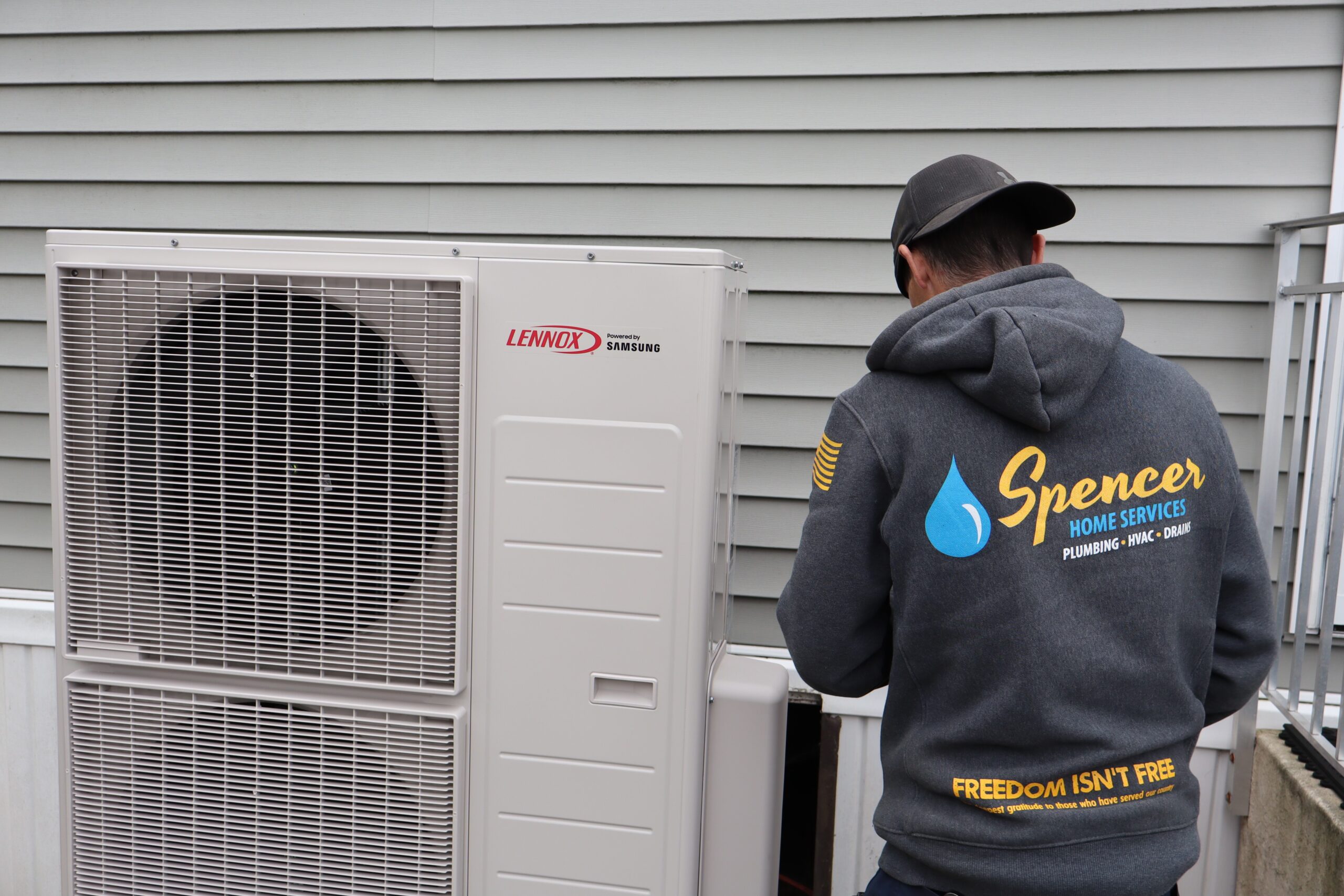 Spencer Home Services technician servicing Lennox heat pump in Peabody MA
