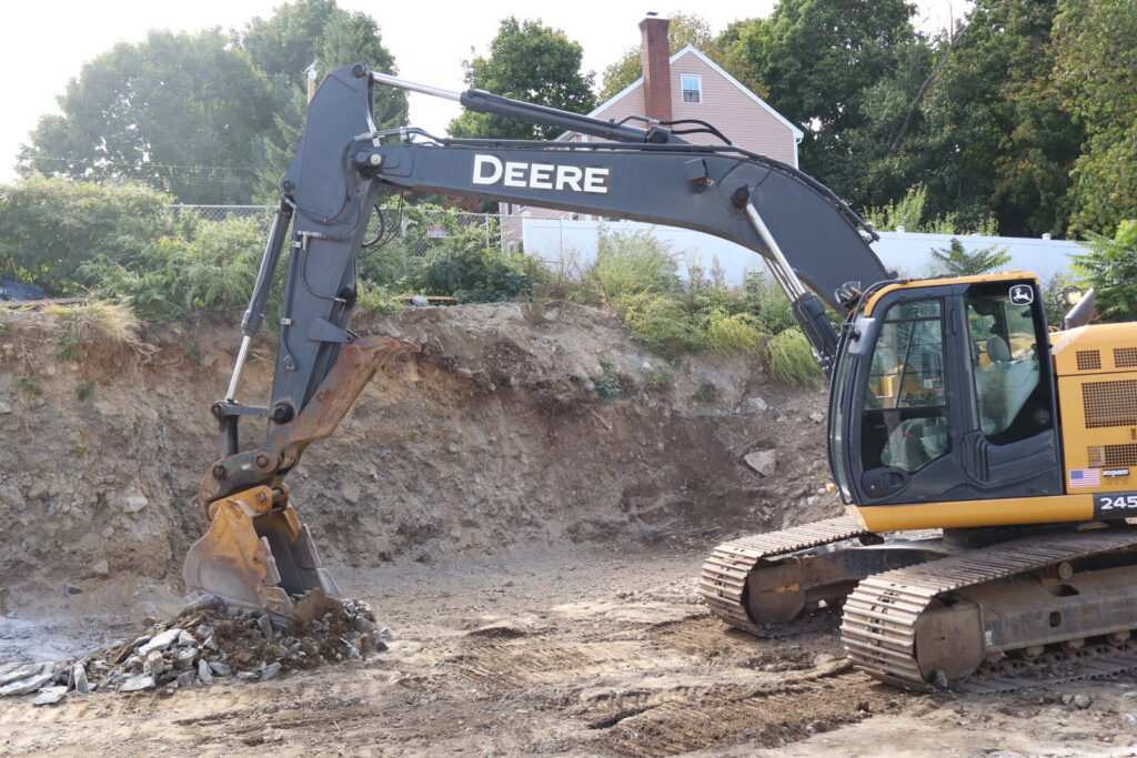 Excavator working in an open residential excavation area