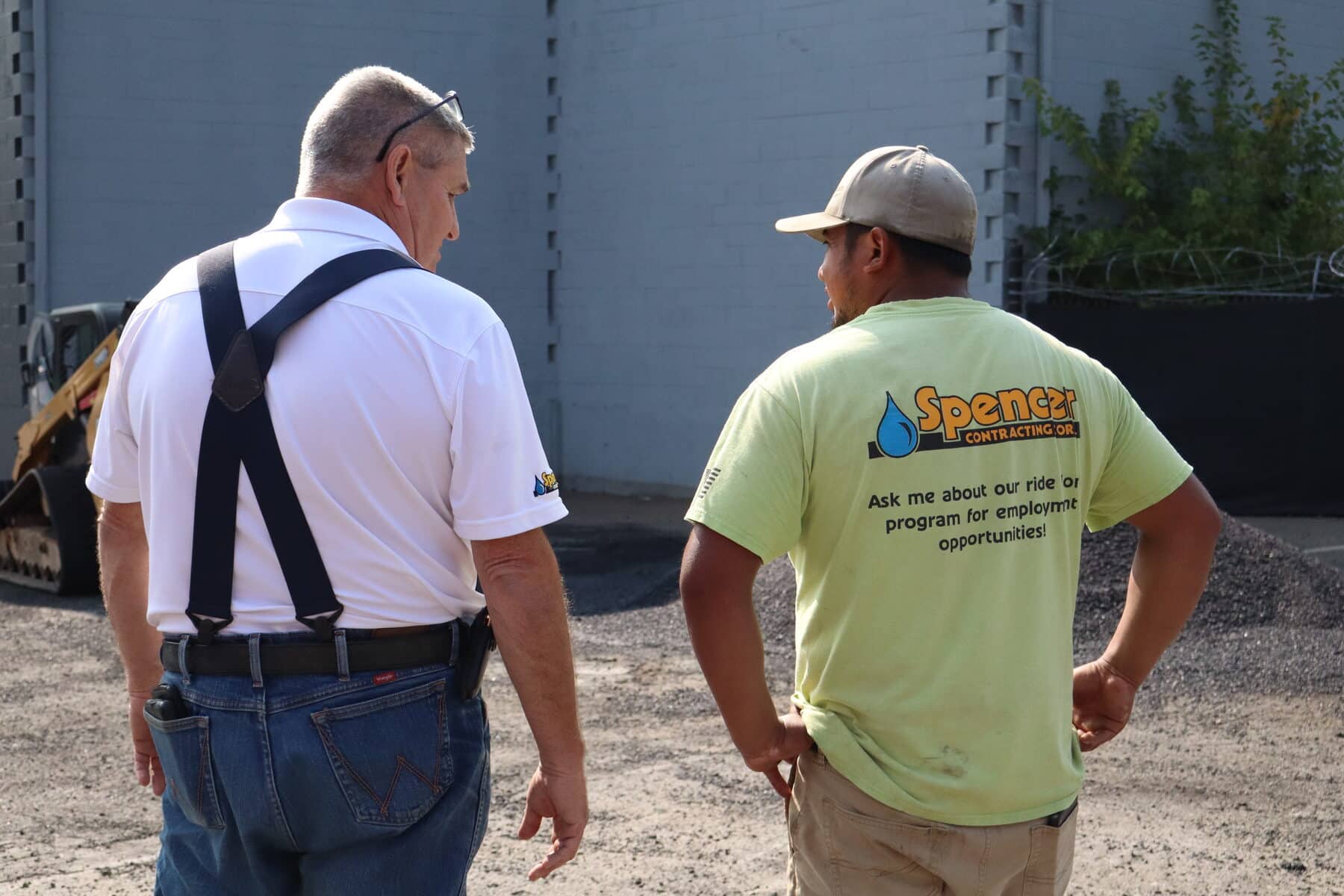 A Spencer Home Services supervisor talks with a field technician at a North Shore jobsite